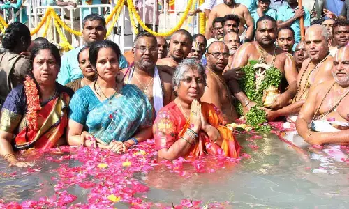 Priests performing Chakrasnanam at the temple tank at Sri Kalyana Venkateswara Swamy temple at Srinivasa Mangapuram on Sunday to mark the conclusion of the nine-day Brahmotsavams