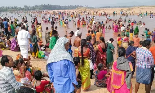 Processional dieties of Srimukhalingam temple being carried by priests to perform Chakrateertha Snanam in the river