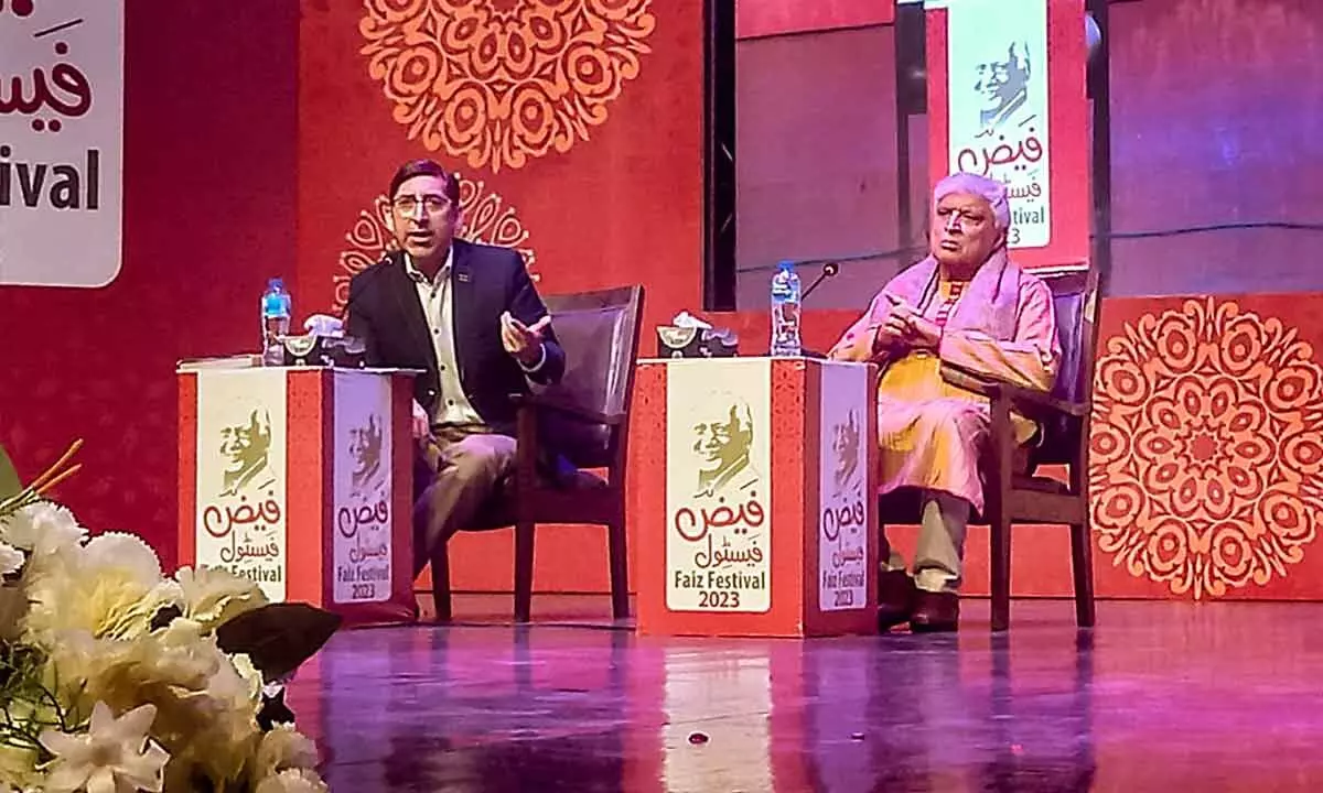 Veteran screenwriter, lyricist and poet Javed Akhtar with host Adil Hashmi at the Faiz Festival in Lahore