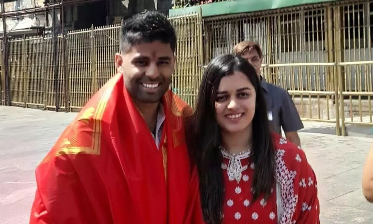 Cricketer Surya Kumar Yadav with  his wife in front of Tirumala temple on Tuesday