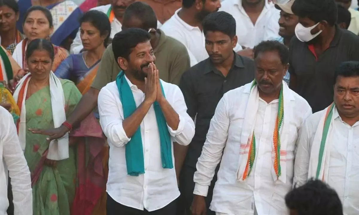 TPCC president A Revanth Reddy greets people during his Hath Se Hath Jodo yatra in Bhupalpally constituency on Wednesday. Congress Bhupalpally constituency in-charge Gandra Satyanarayana Rao is also seen besides Revanth