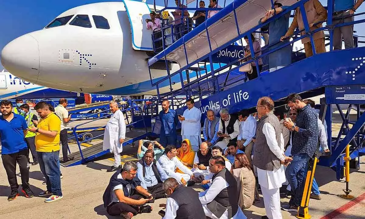 Congress leaders stage a protest dharna at the IGI Airport after the party leader Pawan Khera was allegedly deboarded from the plane owing to an FIR against him, in New Delhi on Thursday