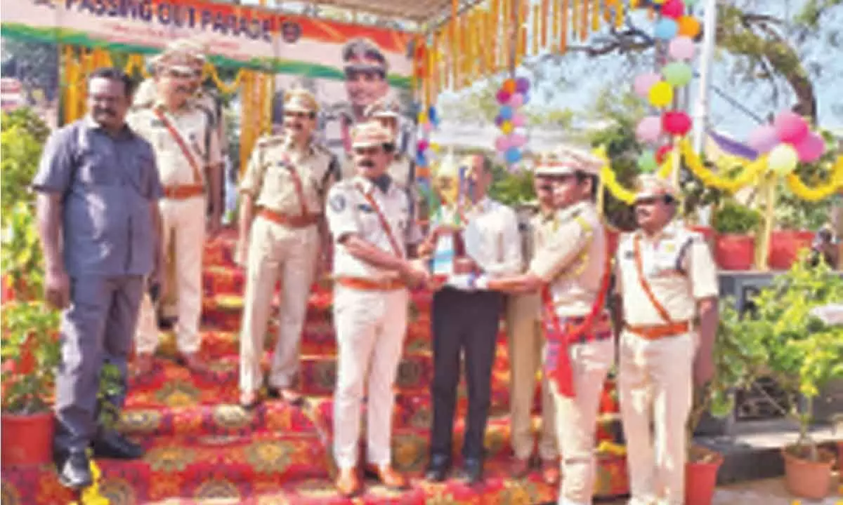 Ongole PTC Principal AR Damodar presenting best all-rounder award to P Pruthviraj at the passing out parade in Ongole on Friday