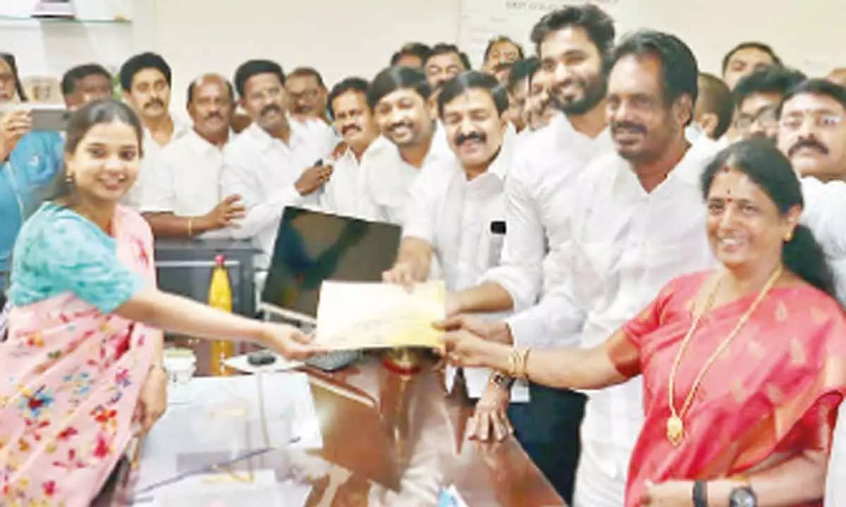 Returning Officer and Joint Collector Ilakkiya handing over the victory certificate to MLC Kudipudi Suryanarayana Rao in Kakinada on Monday