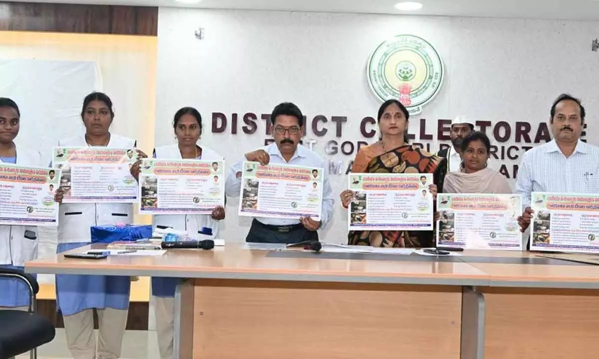 District Collector K Madhavi Latha along with district Animal Husbandry department officer Satya Govind and others releasing posters on the FMD vaccination programme at the Collectorate in Rajamahendravaram on Monday