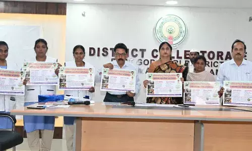 District Collector K Madhavi Latha along with district Animal Husbandry department officer Satya Govind and others releasing posters on the FMD vaccination programme at the Collectorate in Rajamahendravaram on Monday