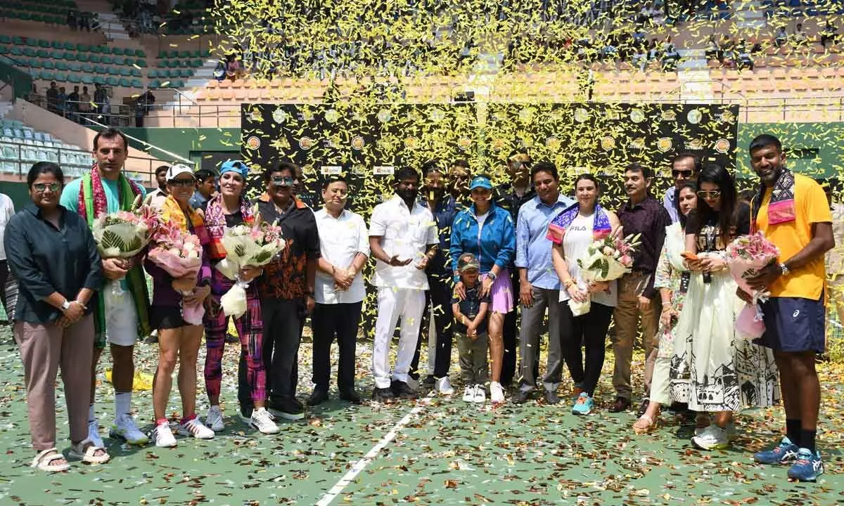 Tennis player Sania Mirza stands with her son and officials during her farewell at the Lal Bahadur Stadium, in Hyderabad, Sunday. (Photos: G Ramesh)