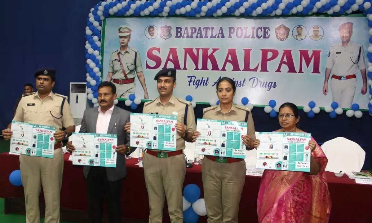 Bapatla district SP Vakul Jindal, Prakasam district SP Malika Garg, police officials releasing Sankalpam brochure in Bapatla on Tuesday