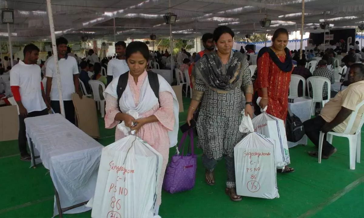 Election staff collecting material from their distribution centre in Ongole on Sunday