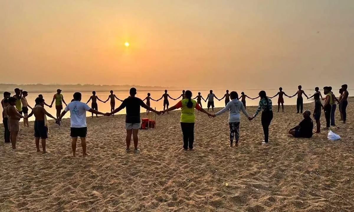 Kids enjoying the sunset on the river bank as part of ‘Children for Nature’ camp in Vijayawada on Sunday