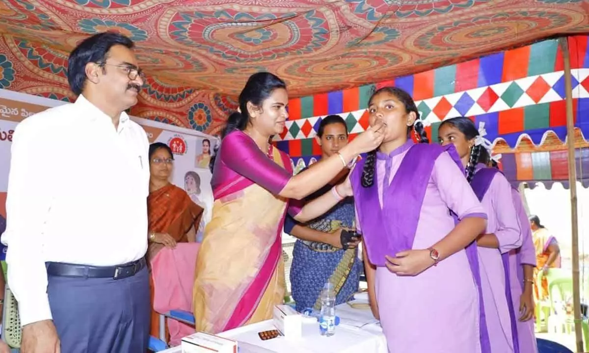 Health Minister Vidadala Rajini administering Albendazole tablet to a student at Chinakakani  Government School on Tuesday
