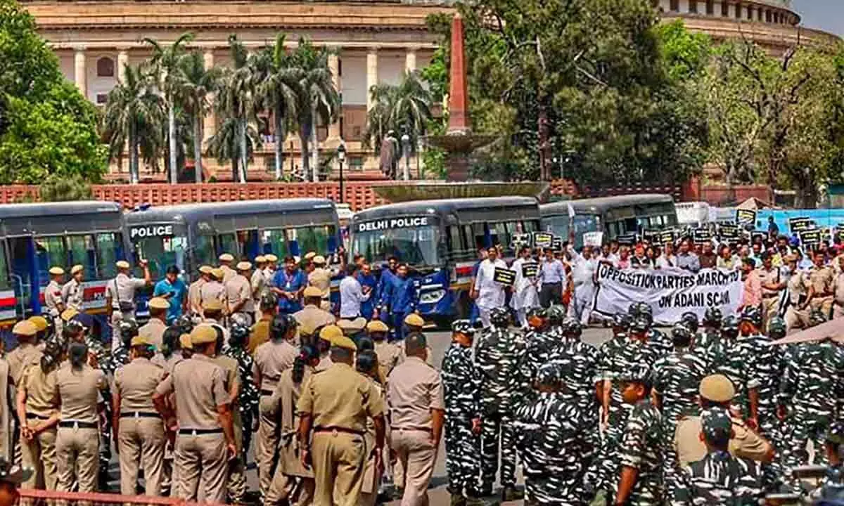 Security personnel deployed during a march of Opposition MPs from Parliament House to ED office to submit a complaint over the Adani issue, in New Delhi on Wednesday
