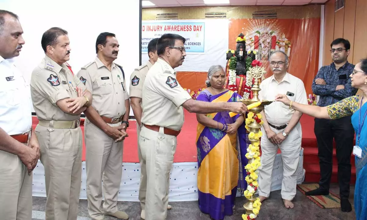 Tirupati traffic  DSP Katamaraju  inaugurating an  awareness  programme by  lighting the lamp. SVIMS Director  Dr B Vengamma  and other police  officials are seen.