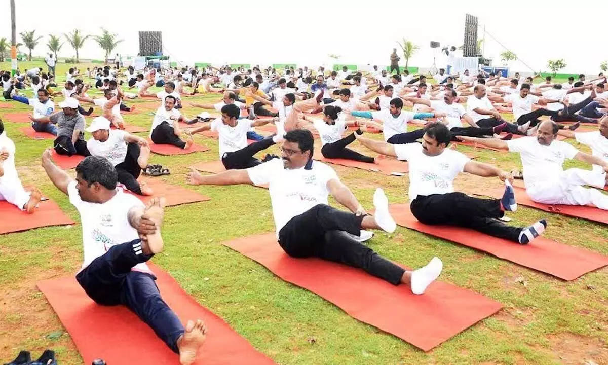 Municipal Corporation Commissioner P Raja Babu and others demonstrating yoga in Visakhapatnam on Tuesday