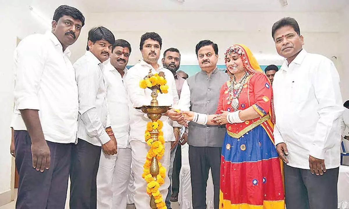 District Collector K Venkataramana Reddy, ST Commission member Vadithya Shankar Naik and others lighting the lamp to mark the inauguration of the tribal cultural festival in Tirupati on Sunday