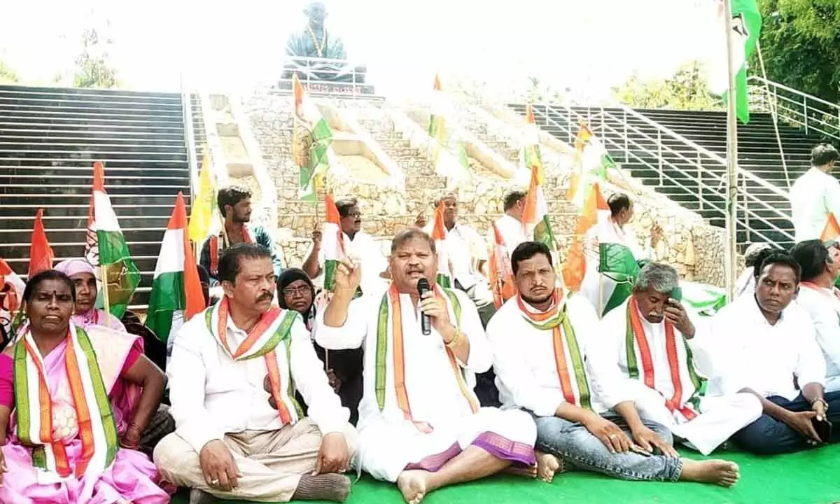 District Congress Committee president M Sudhakar Babu addressing the Satyagraha Deeksha staged in front of Gandhi’s statue at Zilla Parshad office in Kurnool on Sunday.  Party district general secretary Kothuru Sathyanarayana Gupta and other leaders are also seen.