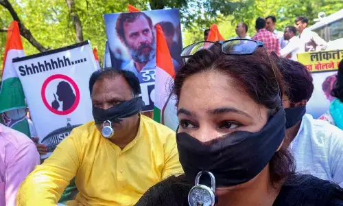 Congress workers stage a protest against the Union Government over disqualification of Congress leader Rahul Gandhi from the Lok Sabha in Bhopal on Saturday