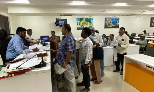 Civic chief K Dinesh Kumar receiving petitions from people during Spandana programme in Rajamahendravaram on Monday