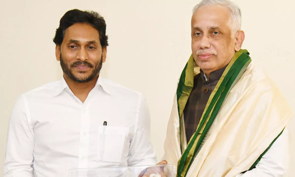 Chief Minister Y S Jagan Mohan Reddy presents a gift to Governor S Abdul Nazeer when he made a courtesy call at Raj Bhavan in Vijayawada on Monday
