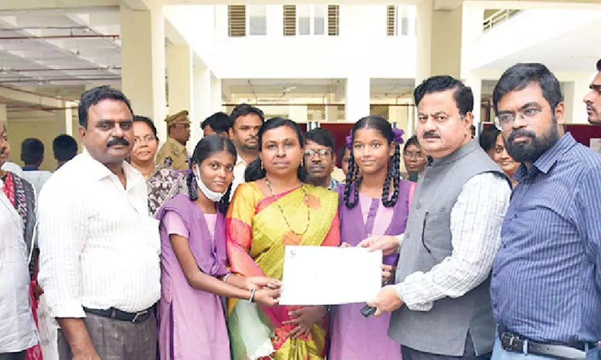 District Collector K Venkataramana Reddy presenting the best Green School certificates in Tirupati on Monday