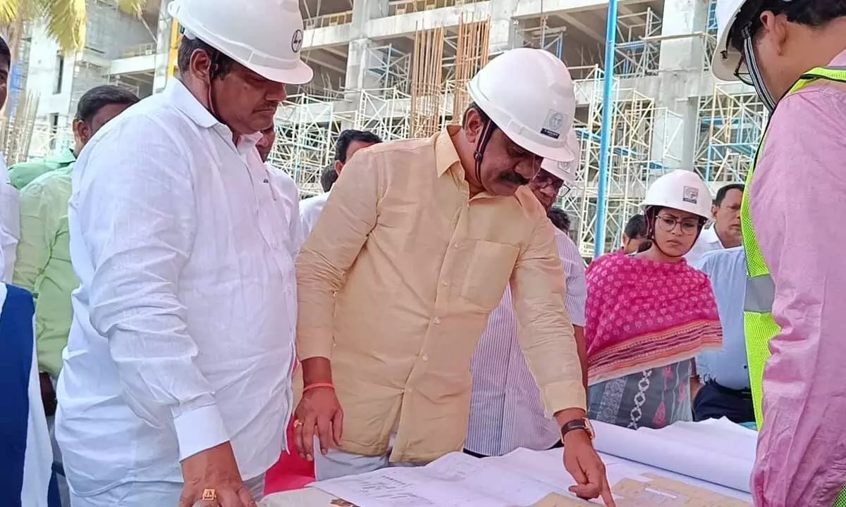 R&B Minister Vemula Prashanth Reddy along with MLA Nannapuneni Narender inspecting the progress of 24-level super multi-speciality hospital construction in Warangal on Monday