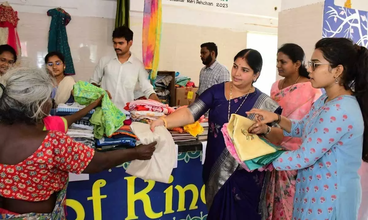 Mayor R Bhagyalakshmi distributing cloth bags to the public in Vijayawada on Tuesday
