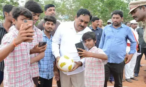 Minister for Panchayat Raj and Rural Development Errabelli Dayakar Rao posing for a selfie at the Zilla Parishad High School in Kothur under Raiparthy mandal of Warangal district on Monday