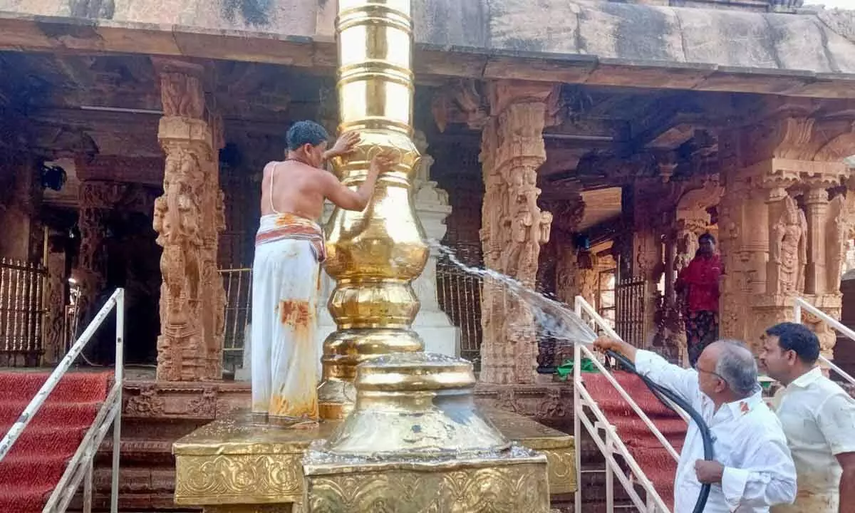 Temple staff cleaning Sri Kodandarama Swamy temple at Vontimitta in YSR district as part of Koil Alwar Tirumanjanam on Tuesday as a preparatory exercise for the annual Brahmotsavam in the temple