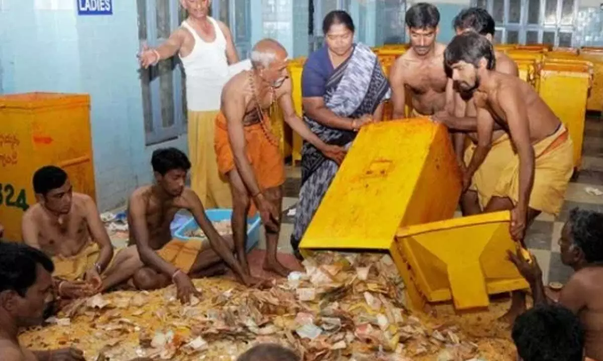 File picture of staff counting Hundi collection at Parakamani in Tirumala