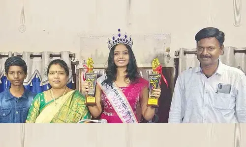 Bhavana showing her shields to the media in Tirupati on Tuesday. Her parents Gopi Krishna and Lakshmi and brother Darahas are also seen.