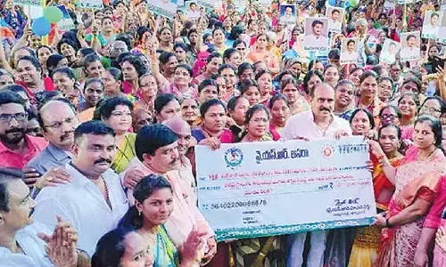 MLA Balineni Srinivasa Reddy distributing cheques of third tranche of YSR Aasara at Ongole  Municipal Corporation on Sunday