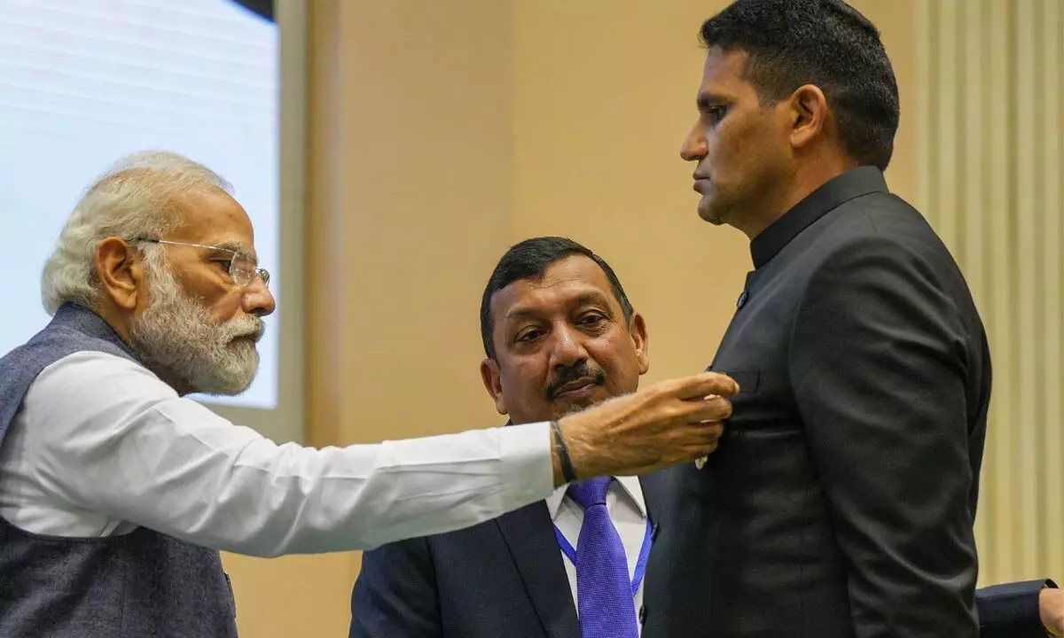 Prime Minister Narendra Modi presents President’s Police Medal to Mehboob Hasan, Head Constable, CBI Headquarters, during the diamond jubilee celebrations of Central Bureau of Investigation (CBI), in New Delhi on Monday