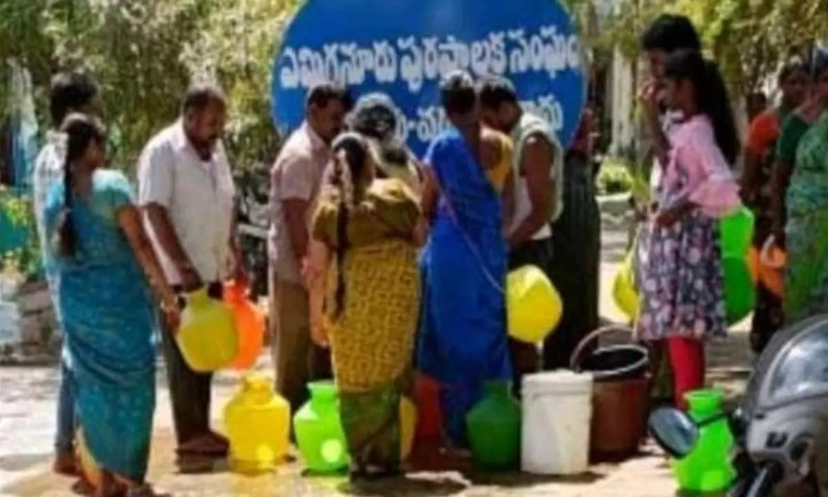 Residents of SMT Colony in Yemmiganur wait in a queue at a tanker to fetch drinking water
