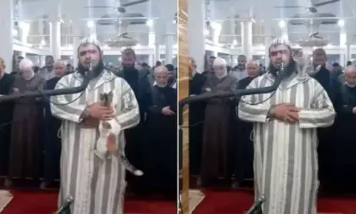 A Cat Jumping On Imam As He Recites Prayer