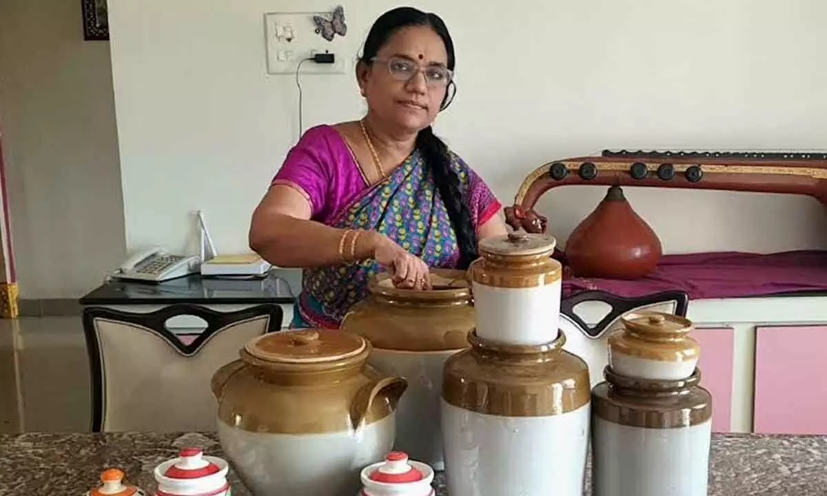 A woman taking out ceramic jars to sun-dry them ahead of making ‘avakaya’ at HB Colony in Visakhapatnam