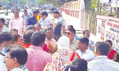 Parents questioning the police for not allowing their wards to the exam centre with a wrist watch and water bottle in Visakhapatnam