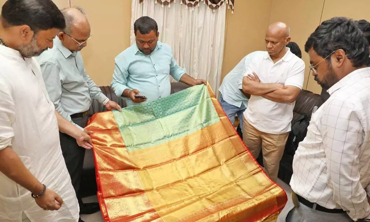 AP Chief Secretary Dr K S Jawahar Reddy having a look at the gold vastram, which was donated by a Telangana weaver Nalla Vijay to TTD, in Tirupati on Sunday