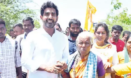 TDP national general secretary Nara Lokesh with an elderly woman during his padayatra in Anantapur on Monday