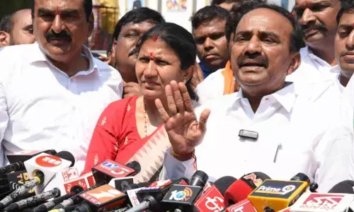 Huzurabad BJP MLA Eatala Rajender speaking to media persons outside the Police Commissionerate in Hanumakonda on Monday. Warangal Urban Cooperative Bank chairman Errabelli Pradeep Rao and Hanumakonda district president Rao Padma are also seen