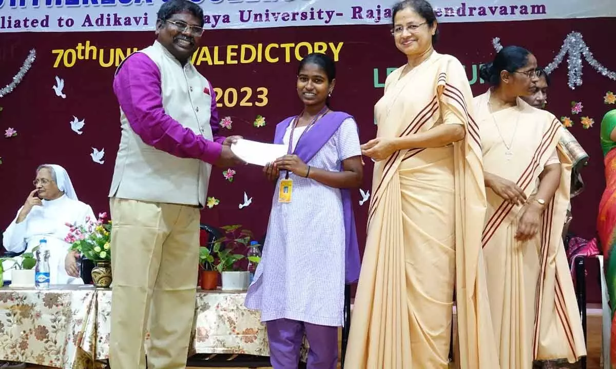 IMRF CEO Prof Dr Ratnakar DB presenting merit certificate to a student at a programme at Ch S D St Theresa’s College for Women (A) in Eluru on Tuesday