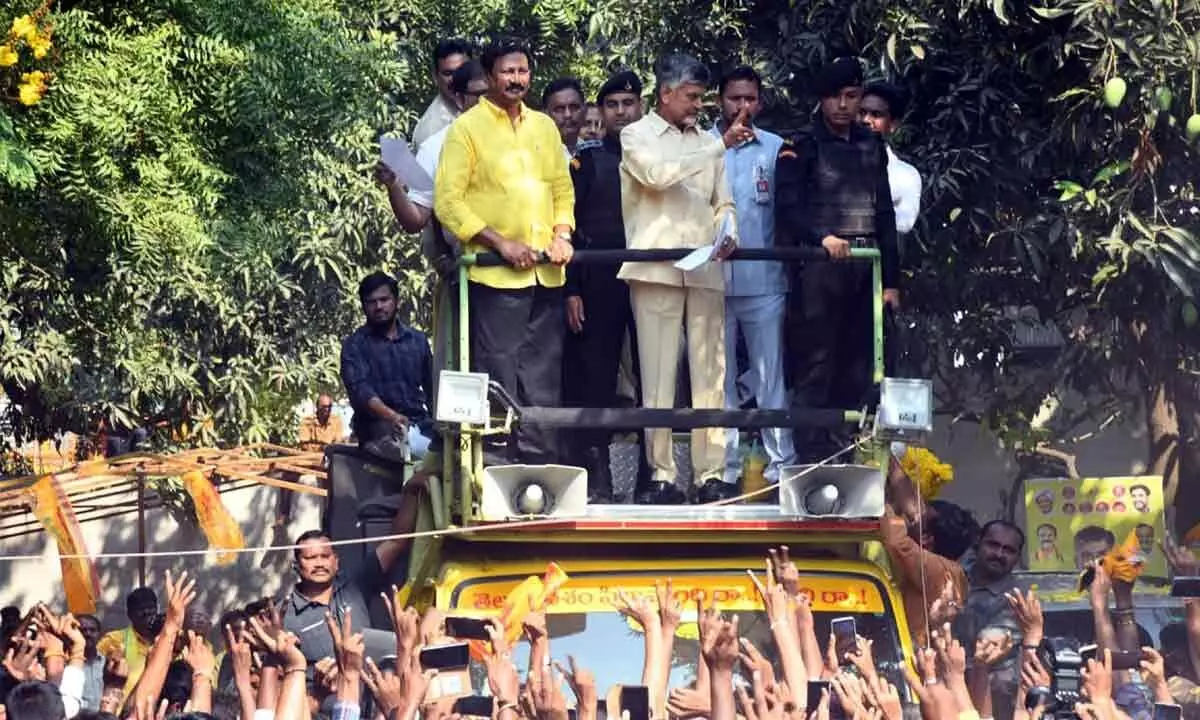 TDP national  president  N Chandrababu Naidu greeting people during a road show in Vijayawada on Wednesday.  MLA Gadde Rammohan is also seen.