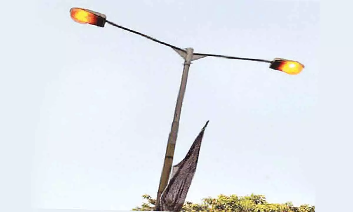 A picture of streetlights on during daytime in  rural  Anantapur