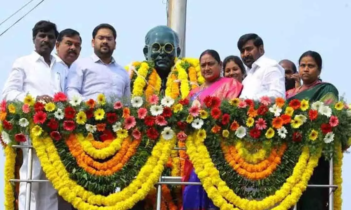 Minister Jagadish Reddy garlanding the statue of BR Ambedkar in Suryapet on Friday