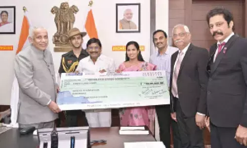Dr A Sridhar Reddy, Chairman, and AK Parida, General Secretary & CEO of Indian Red Cross Society, AP State branch, handing over a cheque towards Climate Action Fund to Governor and President of IRCS of AP S Abdul Nazeer at Raj Bhavan in Vijayawada on Thursday