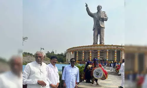 Transport Minister Puvvada Ajay Kumar posing before the 125-foot statue of Dr BR Ambedkar after the inaugural ceremony in Hyderabad on Friday