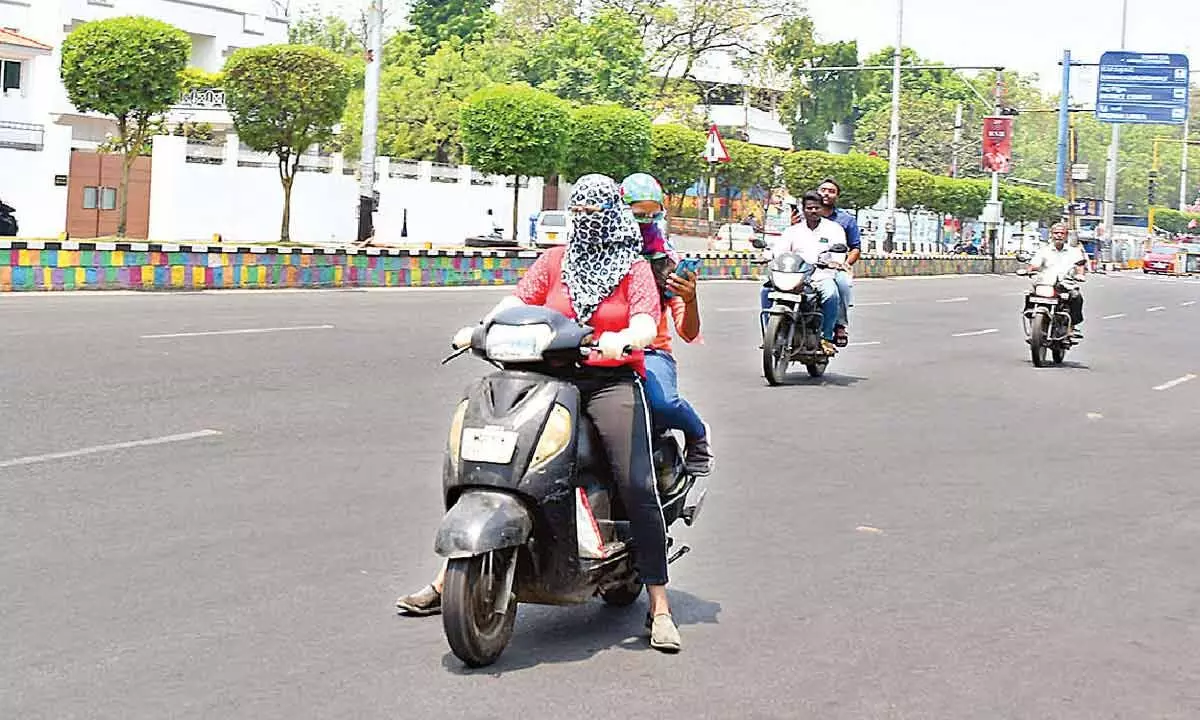 A very few two-wheeler riders  are seen on the ever busy MG Road in Vijayawada as the city  experienced scorching heat on Sunday Photo: Ch V Mastan