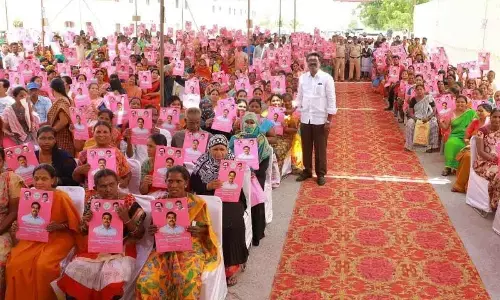The beneficiaries who received pattas and double bedrooms taking a photo with Transport Minister Puvvada Ajay Kumar in Khammam on Monday