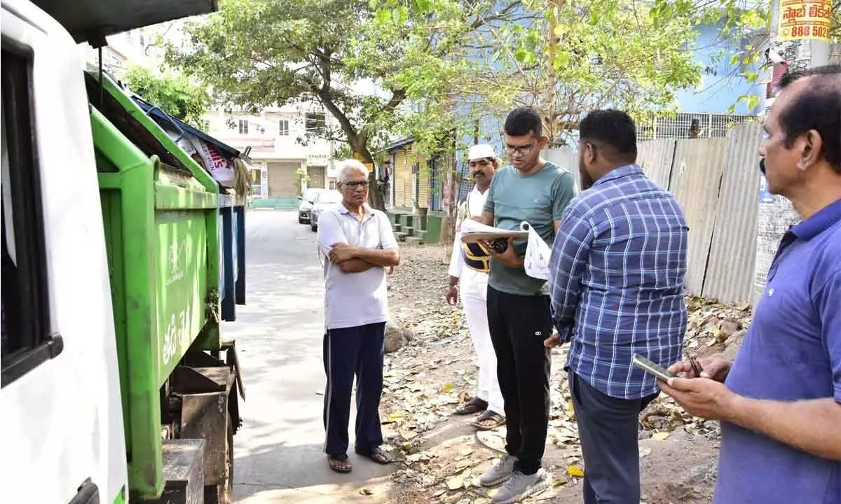 VMC Commissioner Swapnil Dinkar Pundkar verifying the sanitation staffs register in Vijayawada on Tuesday