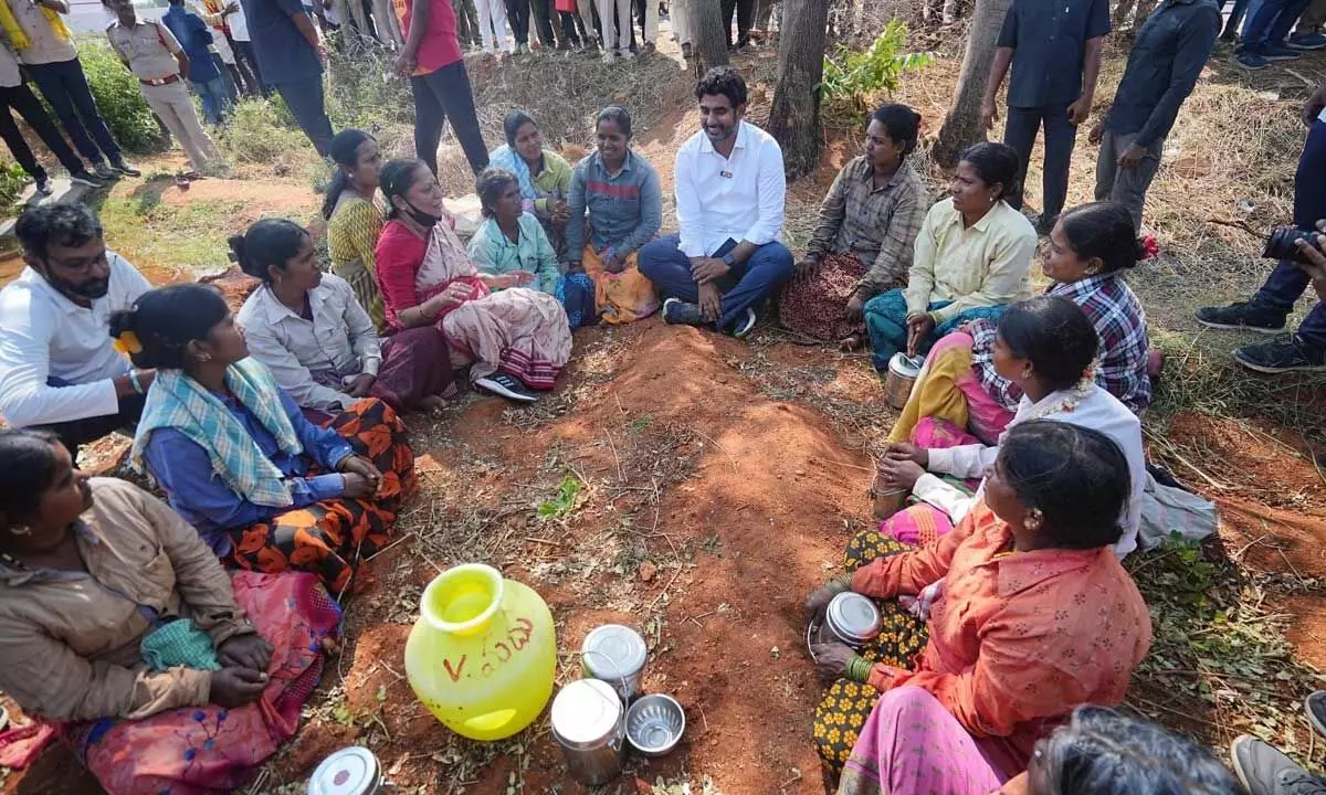 TDP national general secretary Nara Lokesh interacting with women during his Yuva Galam padayatra in Devanakonda mandal in Alur constituency on Tuesday