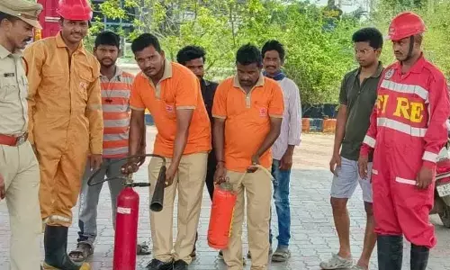 Fire department officials performing demonstration at petrol bunk in Srikakulam on Tuesday